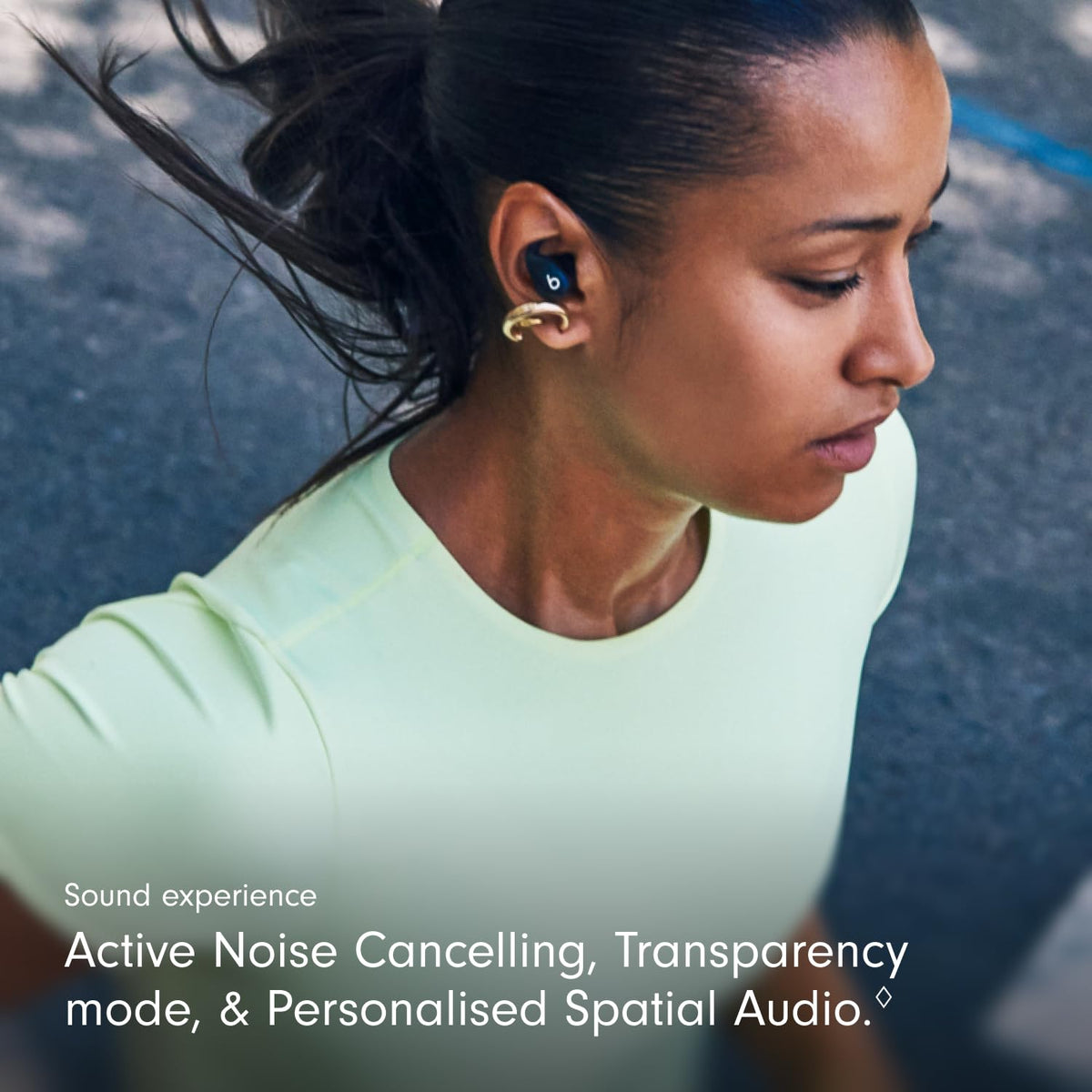 Beats Powerbeats Fit IPX4 sweat resistance shown for gym sessions in rain.