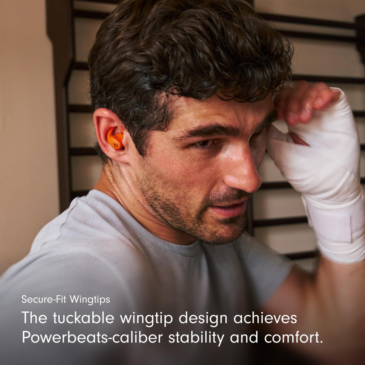 Beats Powerbeats Fit secure-wingtip close-up emphasizing stable fit during workouts