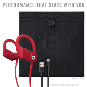 Beats Powerbeats red lifestyle shot in action during outdoor run.