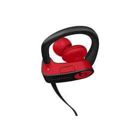 Beats Powerbeats3 next to credit card for scale comparison to show compact portable size