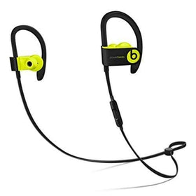 beats Powerbeats3 beside smartphone illustrating compact scale and easy portability