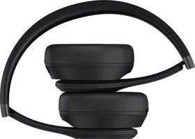 Beats Solo 4 on-ear headphones worn with a smartphone for wireless freedom.
