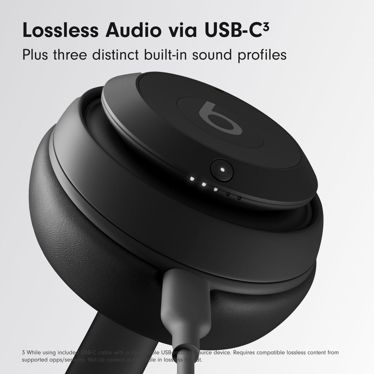 Beats Studio Pro earcup close-up in black with plush cushions.