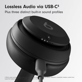 Beats Studio Pro earcup close-up in black with plush cushions.