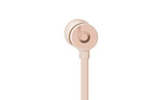 Beats Matte Gold earbud close-up showing eartip and wingtip for secure fit