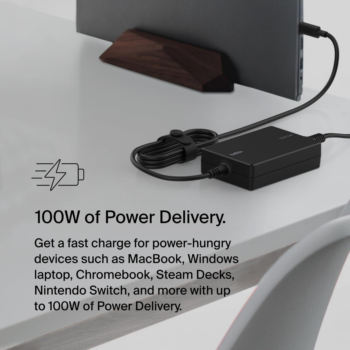 Belkin adapter held in hand to show scale and travel-friendly size for commuters