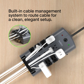 Belkin power strip in a home office setup providing organized power and surge protection benefits