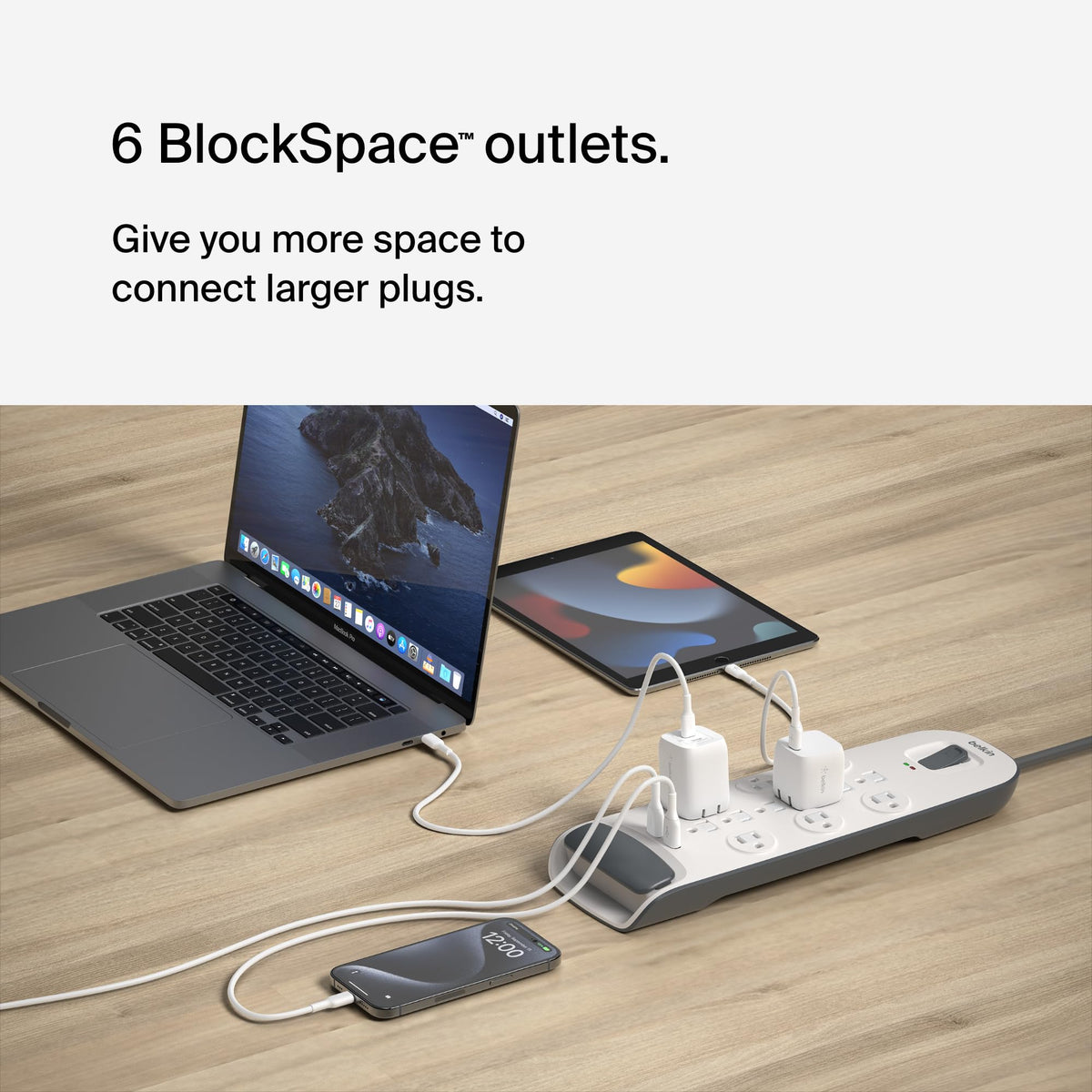 Belkin power strip on a home office desk powering multiple devices benefit