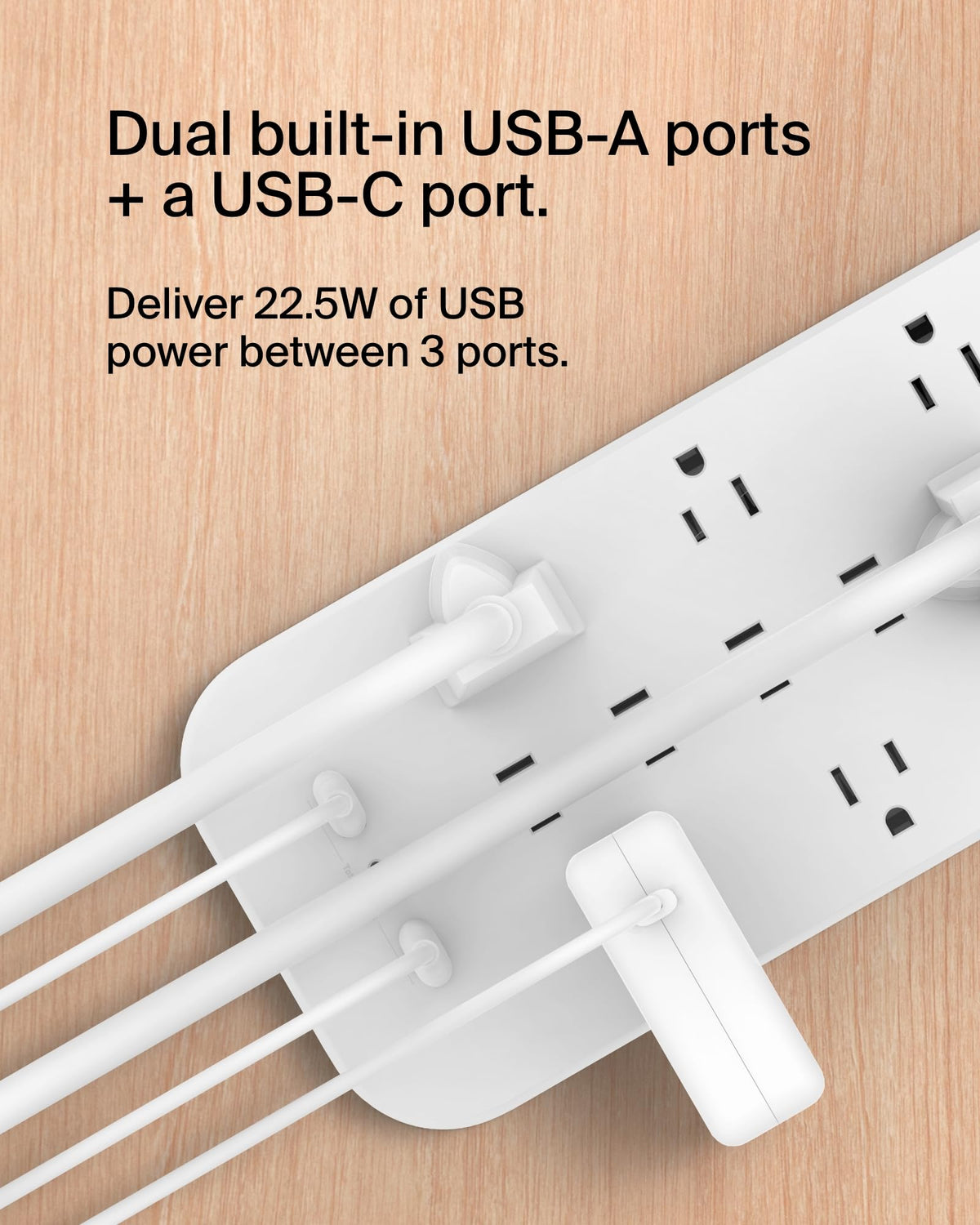 Belkin next to laptop and phone to show scale and multi-device charging benefit