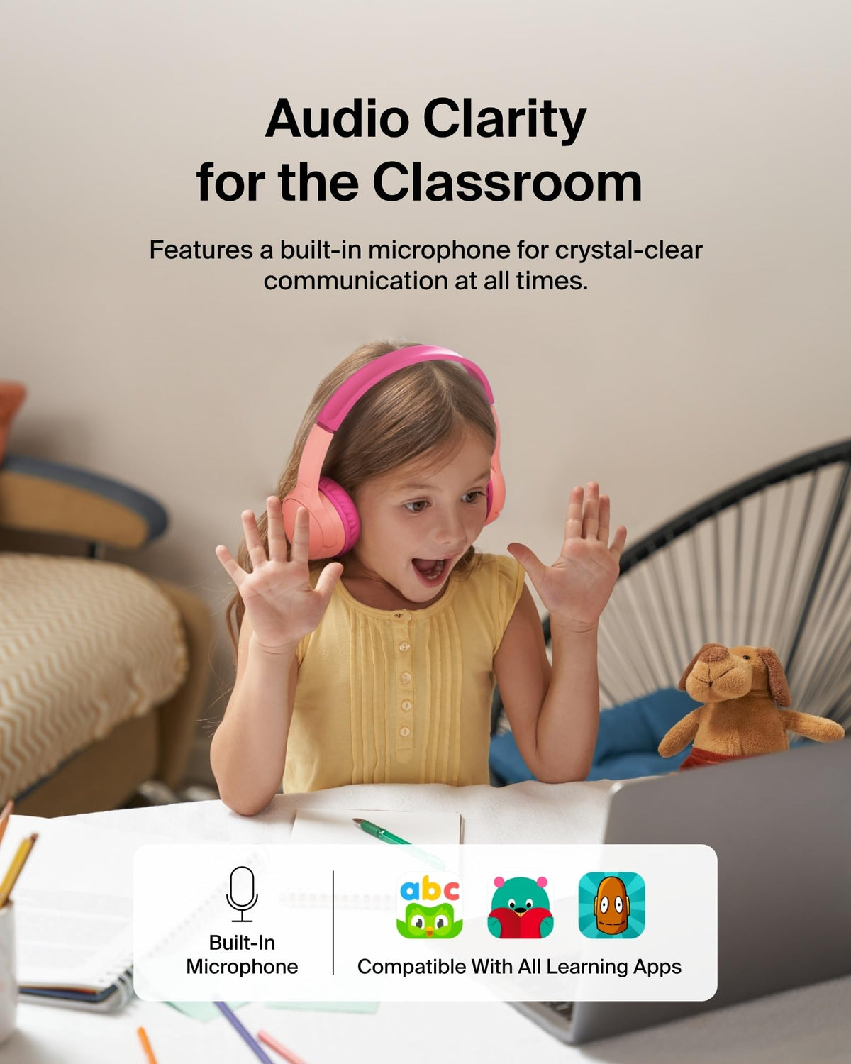 Belkin headphone beside an adult hand to show compact child-sized scale and portability