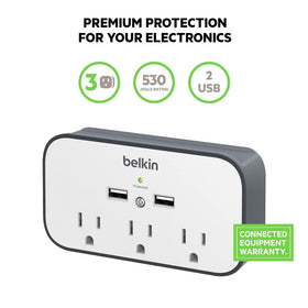 Belkin wall-mount surge protector showing the cradle ledge holding a phone during charging