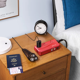 BESTEK next to a smartphone to show compact size and space-saving benefit