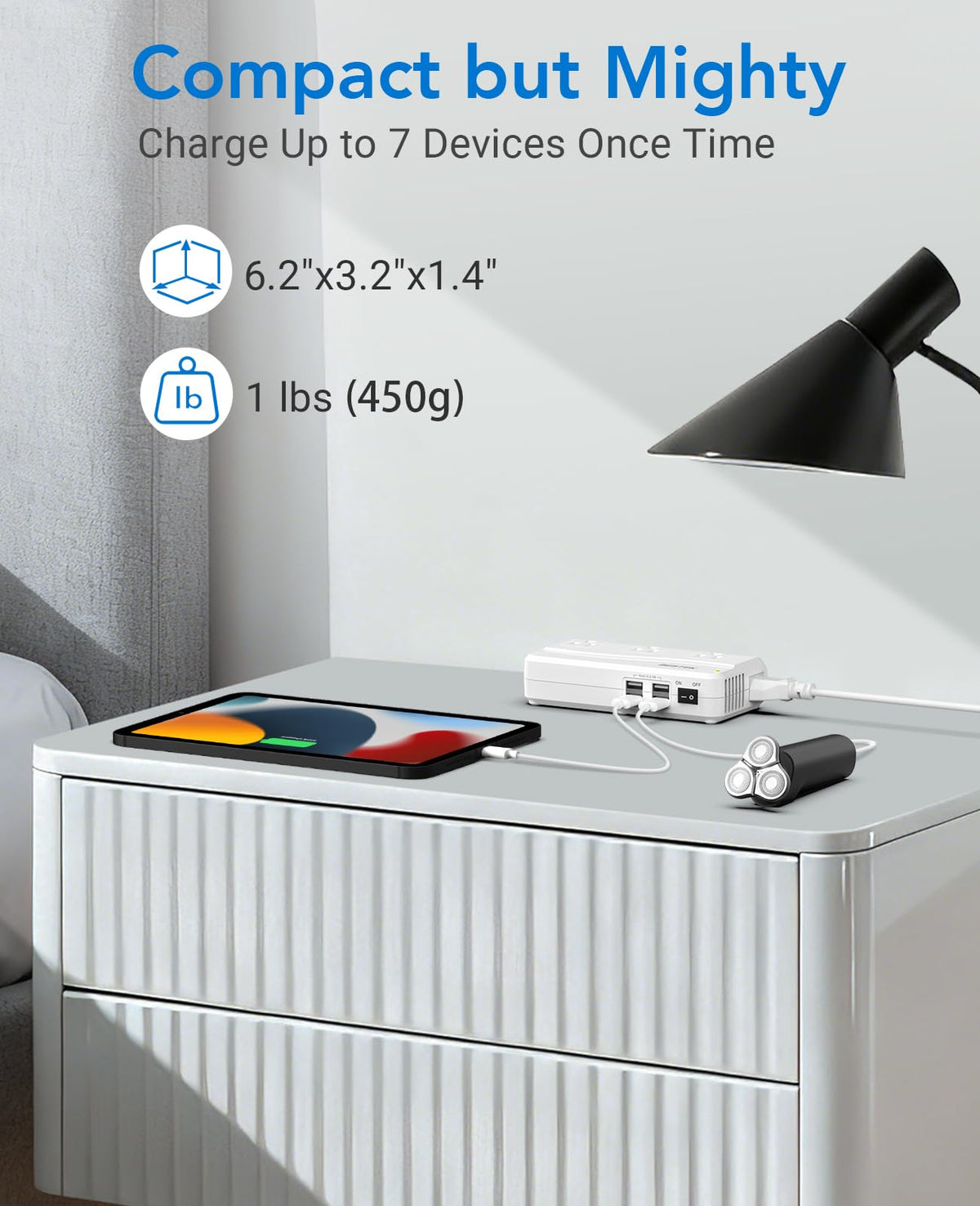 BESTEK beside smartphone for scale showing compact size and travel-ready benefit