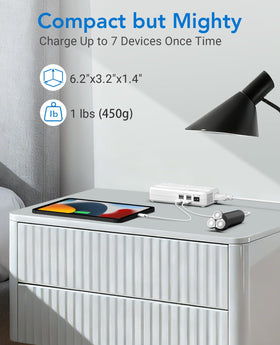 BESTEK beside smartphone for scale showing compact size and travel-ready benefit
