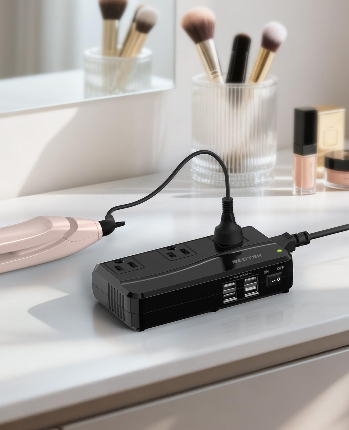BESTEK beside phone and laptop to show compact scale and portability