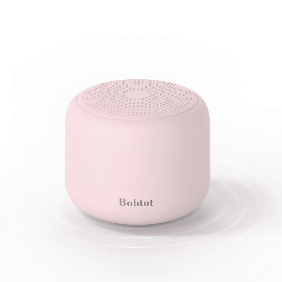 Bobtot portable Bluetooth speaker with pink strap for easy carrying on outdoor adventures.