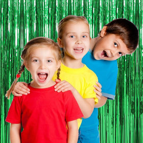 BOMSI photo booth setup with people enjoying vibrant green streamers