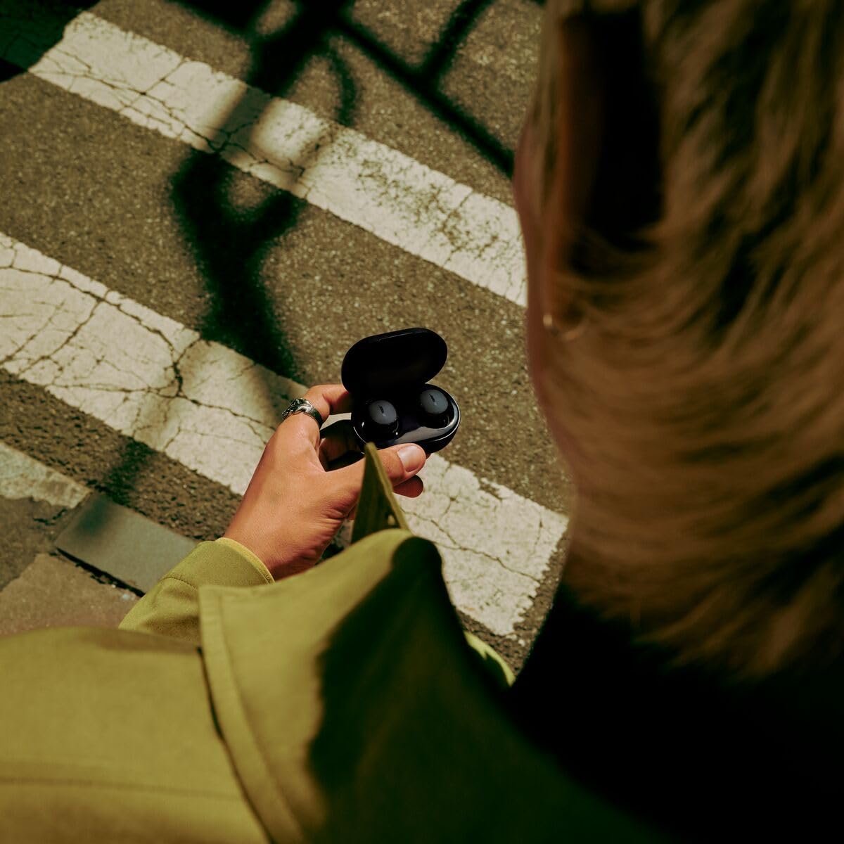 Bose QuietComfort Earbuds worn during commute with active noise cancellation.