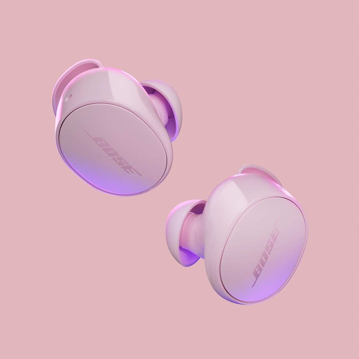 Bose QuietComfort Earbuds Petal Pink earbuds outside the case ready to listen.