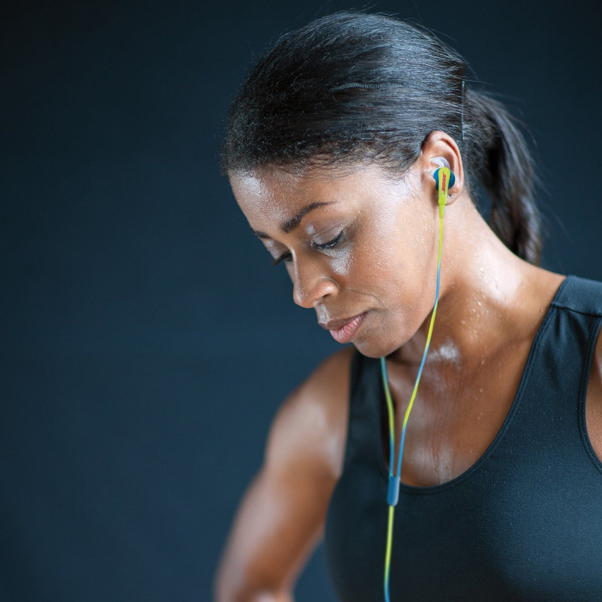 Runner wearing Bose earbuds demonstrating sweat-resistant fit and stable performance