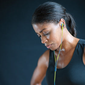 Runner wearing Bose earbuds demonstrating sweat-resistant fit and stable performance