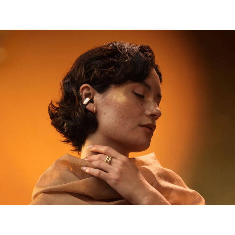 Model wearing Bose Ultra Open Earbuds demonstrating comfortable open-ear fit.