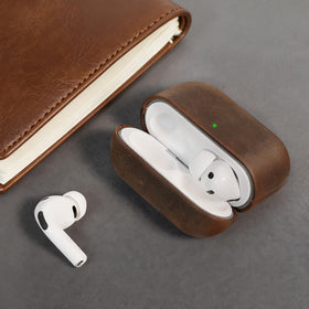 Bouixel leather case next to Apple case showing compact scale and snug fit
