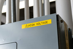 Brady Authentic label showing orange-on-black print for high-visibility identification.