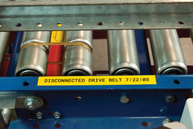 Brady label adhered to painted cinder block showing strong adhesion and legibility