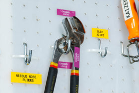Brady white-on-purple label adhered to metal equipment illustrating long-lasting visibility