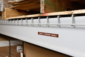 brady label roll beside a hand for scale, showing compact size and large 21-foot length