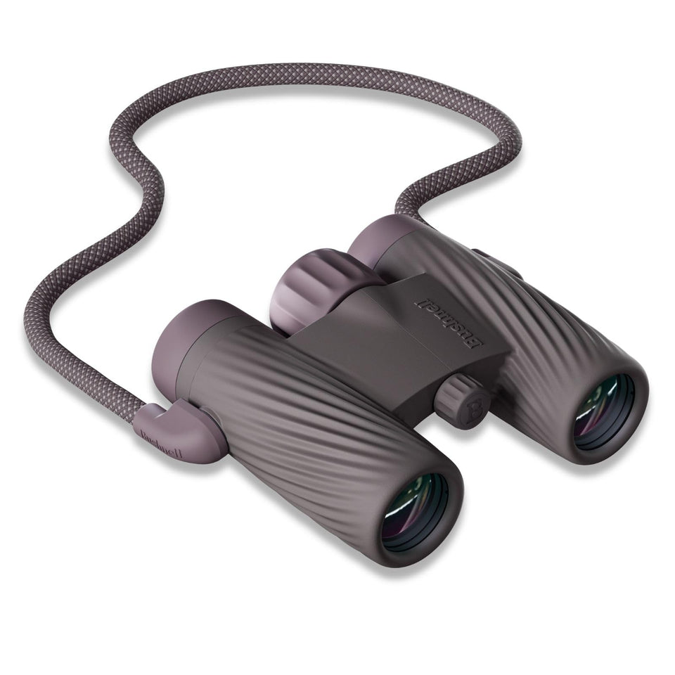 Bushnell A1 8x25 compact binoculars held in hand for easy portability and quick birdwatching.