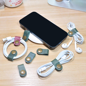 CAILLU earbud case in dark green leather keeps earbuds protected and tangle-free.