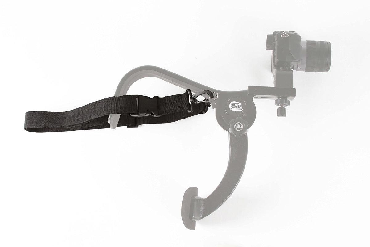 Cam Caddie with camera beside ruler showing compact size and scale