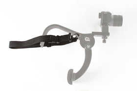 Cam Caddie with camera beside ruler showing compact size and scale