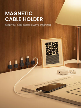 Canisflax clip mounted on nightstand securing phone charging cable tidy