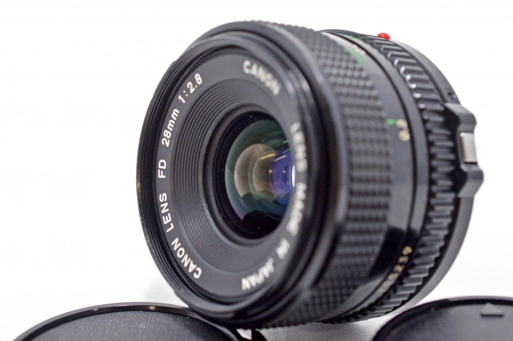 Canon 28mm f/2.8 FD lens side profile showing focus ring and grip