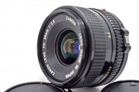 Canon 28mm f/2.8 FD lens side profile showing focus ring and grip