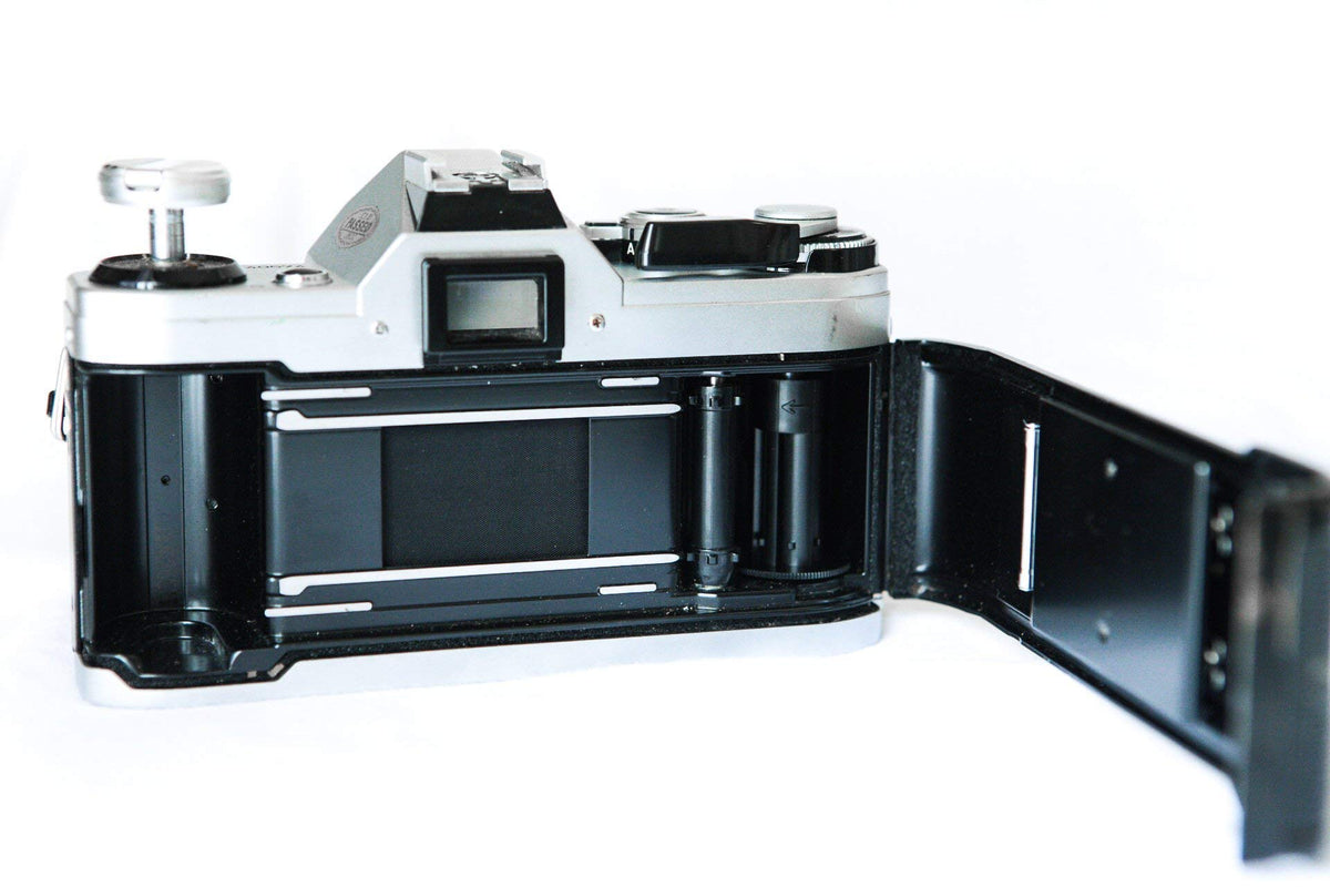 Canon AE-1 metal body texture detail for a retro aesthetic.
