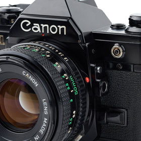 Canon AE-1 metal body—durable construction with vintage aesthetic.