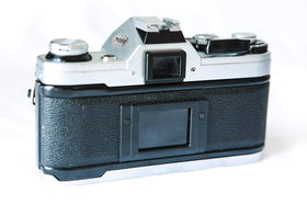 Canon AE-1 side view highlighting classic design and grips.