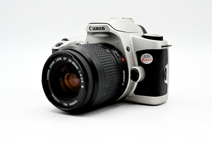 Canon New EOS Kiss front view, compact camera design for travel photography.