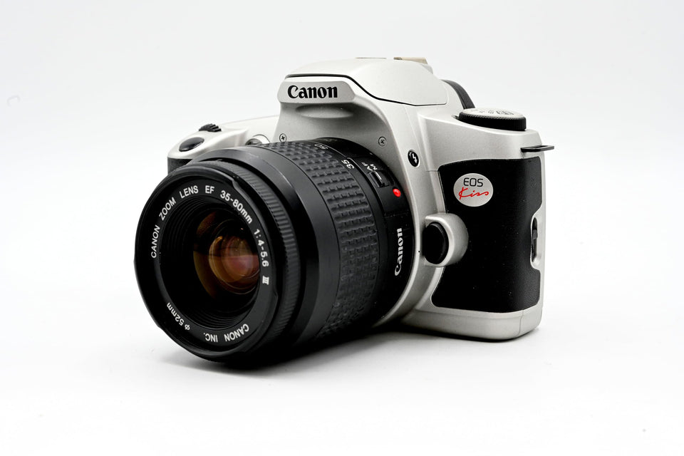 Canon New EOS Kiss front view, compact camera design for travel photography.