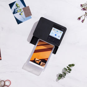 Canon Selphy CP1500 printing 4x6 photos with quick-dry results.