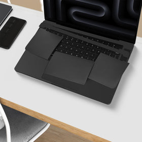 CaseBuy lifted skin beside laptop showing clean aluminum after residue-free removal