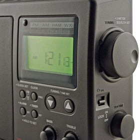 C. Crane CCRadio-2E in-hand usage illustrating portable field listening.