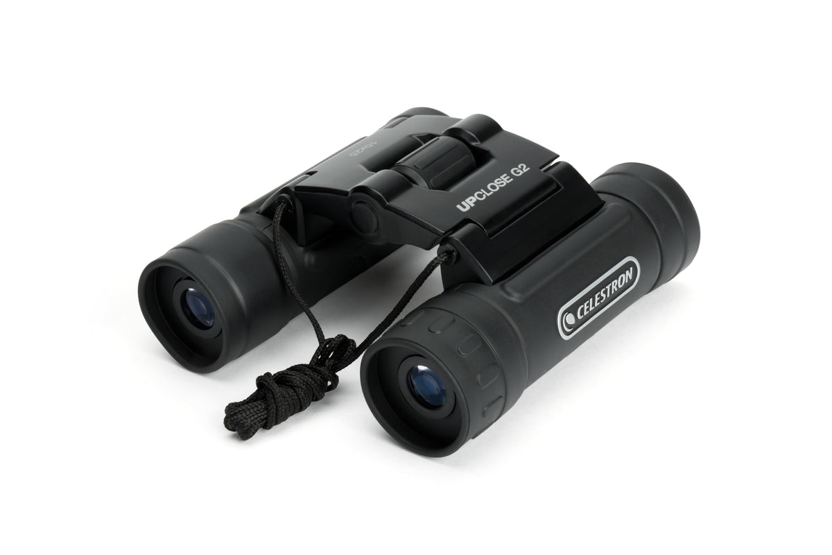 Celestron binoculars held at a stadium illustrating stable, clear viewing