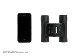 Celestron next to smartphone showing compact size and easy pocketing