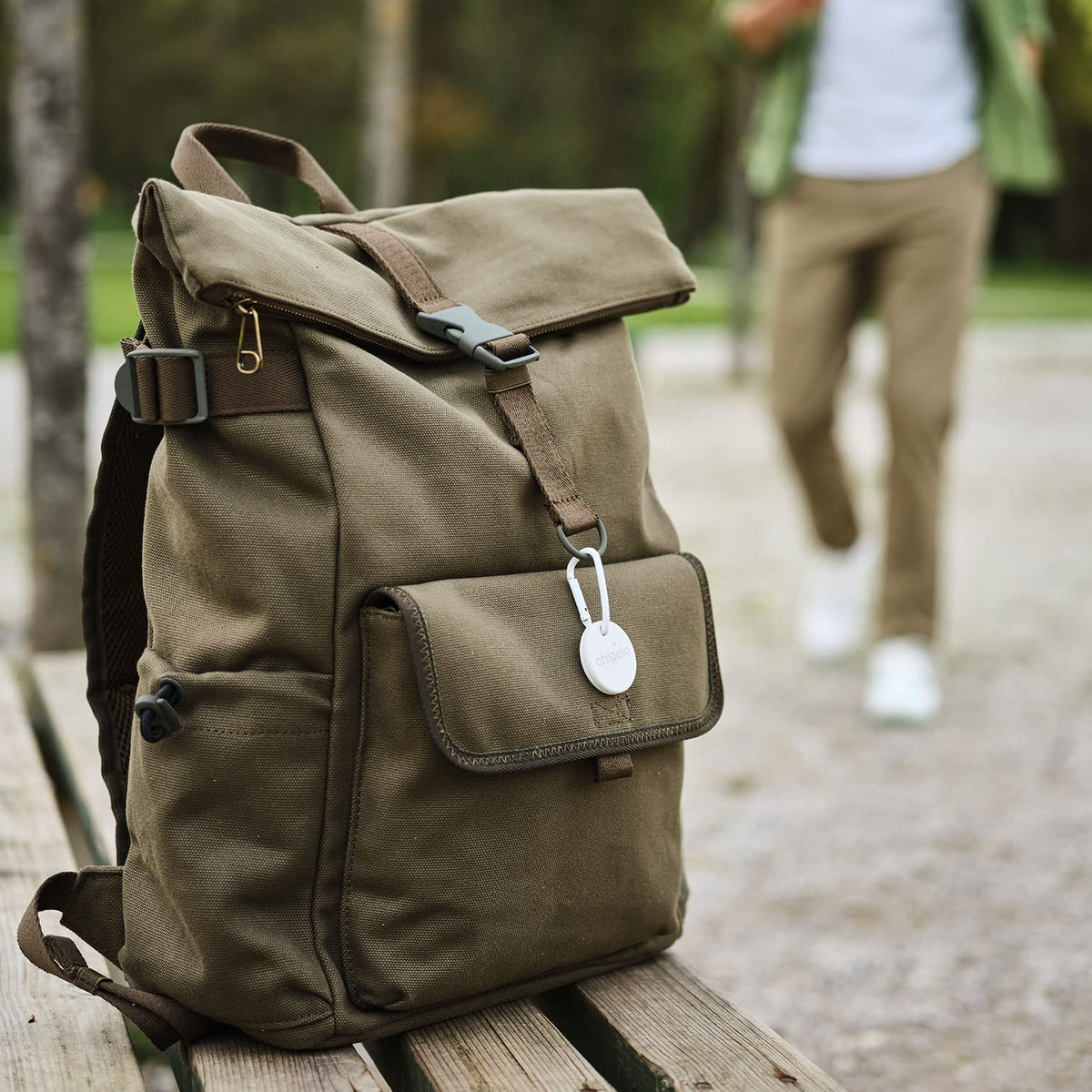Chipolo ONE clipped to a backpack zipper showing travel-ready retrieval benefit