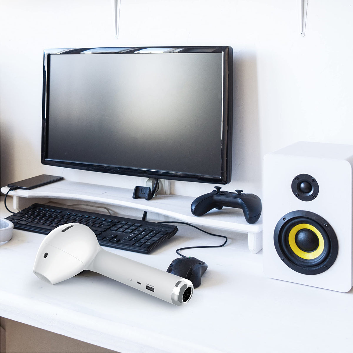 Coby speaker held in hand for scale showing pocketable design and travel convenience